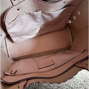 Cream color coach you’re with cut flowers and pink lining. Beautiful bag & used